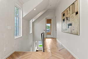 Corridor to primary suite and outdoor sunroom/sitting area