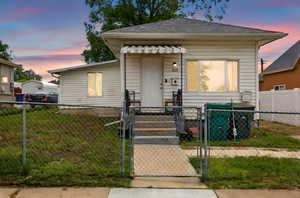 View of front of home featuring a gate
