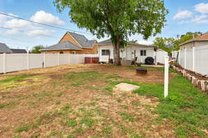 View of yard featuring entry steps and a fire pit