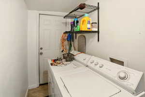 Laundry area featuring washer and dryer and tile patterned flooring