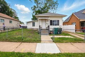 Shotgun-style home featuring a gate