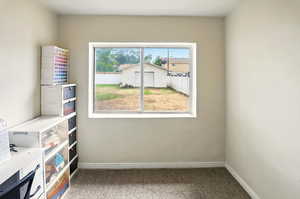 Carpeted empty room with baseboards