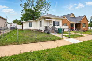 View of front of home featuring a gate