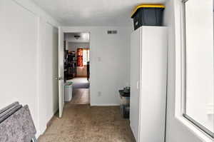 Hall with carpet floors and baseboards