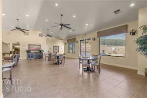 Dining area with ceiling fan, light tile patterned floors, recessed lighting, and high vaulted ceiling