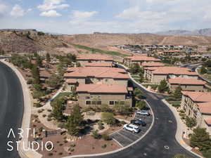 Aerial view of property's location with nearby suburban area and a mountain backdrop