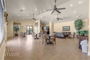 Dining room with a ceiling fan, light tile patterned floors, recessed lighting, and high vaulted ceiling