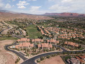 Aerial overview of property's location with a mountainous background and nearby suburban area