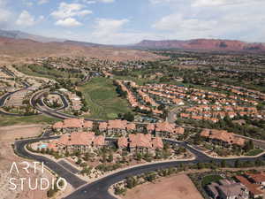 Aerial view of property's location featuring a mountain backdrop and nearby suburban area