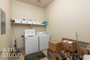 Laundry area featuring independent washer and dryer and electric panel