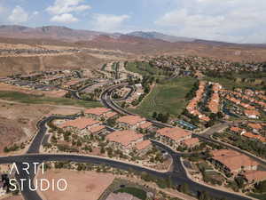 Aerial overview of property's location featuring mountains and nearby suburban area