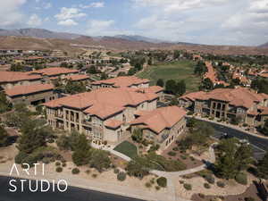 Aerial overview of property's location with a mountain backdrop and nearby suburban area
