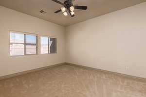Spare room with carpet flooring and a ceiling fan