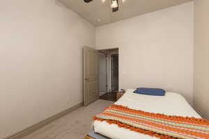 Bedroom featuring light carpet and a ceiling fan