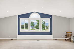 Additional living space featuring light wood-style flooring, vaulted ceiling, baseboards, and recessed lighting