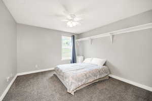 Bedroom with carpet, baseboards, and a ceiling fan