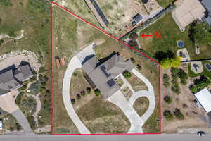 Aerial view of property and surrounding area featuring property parcel outlined