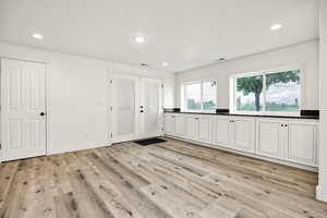 Unfurnished bedroom with light wood finished floors, recessed lighting, and baseboards