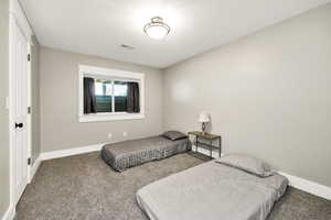 Carpeted bedroom with baseboards and a textured ceiling