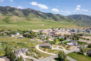 Aerial overview of property's location with nearby suburban area and a mountainous background