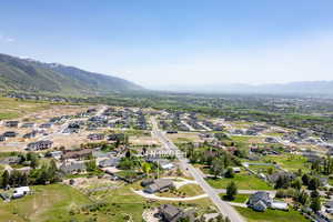 Aerial overview of property's location featuring mountains and nearby suburban area