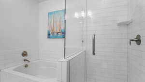 Full bath featuring a shower stall and a garden tub