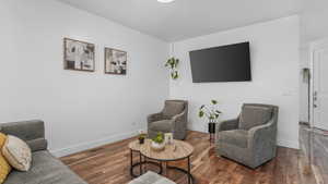 Living room with baseboards and wood finished floors