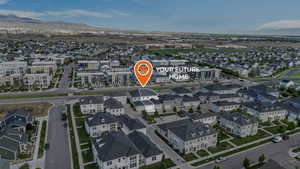 Aerial perspective of suburban area featuring a mountainous background