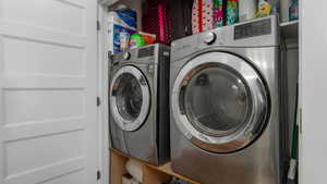 Laundry room with washing machine and clothes dryer