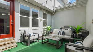 View of patio featuring entry steps and outdoor lounge area