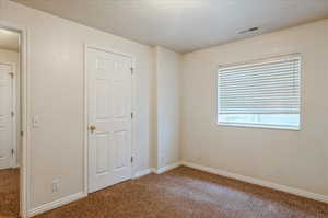 Unfurnished bedroom with carpet and baseboards