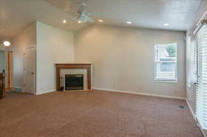 Unfurnished living room with a tile fireplace, carpet, ceiling fan, baseboards, and recessed lighting