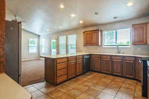 Kitchen featuring a sink, stainless steel appliances, recessed lighting, a textured ceiling, and a peninsula