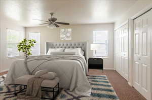 Bedroom with multiple closets, a textured ceiling, baseboards, carpet flooring, and multiple windows