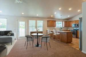 Dining room with recessed lighting and a ceiling fan