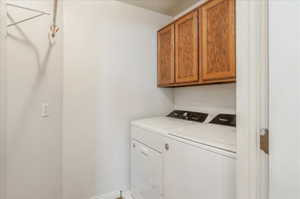 Laundry area featuring cabinet space and washing machine and clothes dryer
