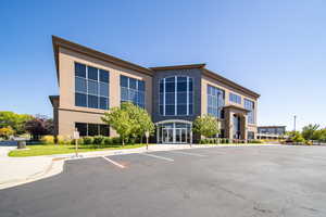View of building exterior featuring uncovered parking