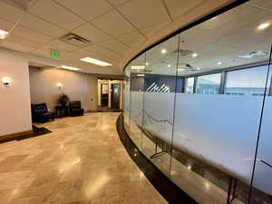 Corridor featuring baseboards, recessed lighting, and stone finish flooring