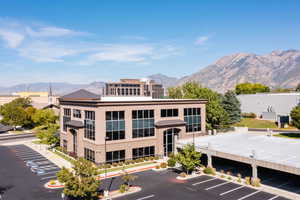 View of property featuring parking garage and a mountain view