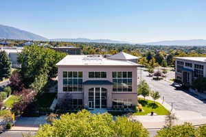Rear view of property with a mountain view and stucco siding