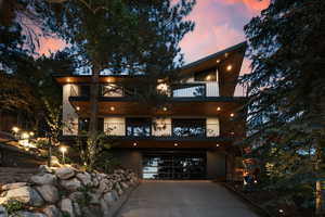 View of front of house featuring a balcony, a garage, and concrete driveway