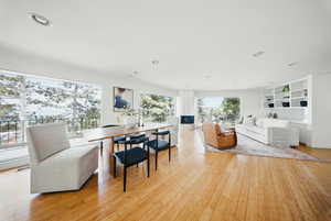 Living room with light wood-style flooring and recessed lighting