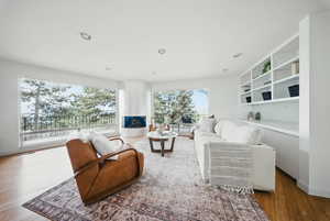 Living room featuring wood finished floors and recessed lighting