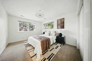 Carpeted bedroom featuring baseboards