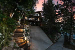 Obstructed view of property with concrete driveway, stairway, and a garage