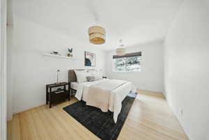 Bedroom featuring wood finished floors and baseboards