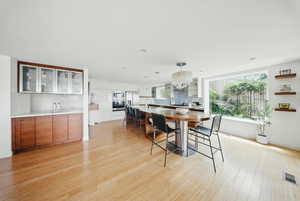 Dining room with light wood-type flooring, plenty of natural light, and recessed lighting
