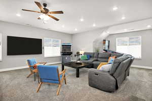 Living room featuring recessed lighting, carpet, baseboards, and a ceiling fan