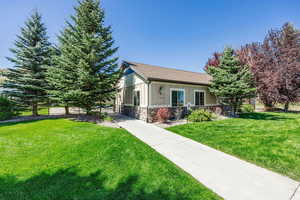 View of front of property with stone siding and board and batten siding