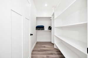 Master Walk in closet featuring wood finished floors